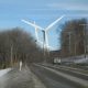 Featured: Car on a dirty snowy road with giant wind turbines in the distance